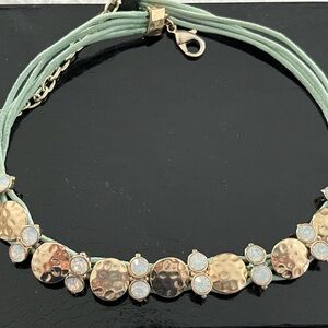 Aqua necklace accented with gold tone and crystals.